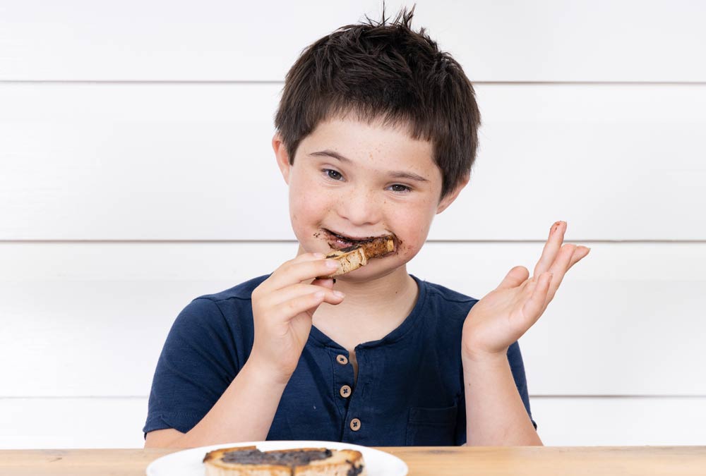 William eating Everymite on Toast